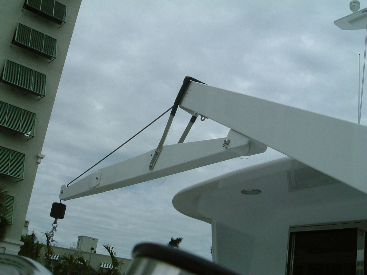 Fold-Under Boom Extension for Davits and Cranes